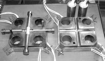 The multi-axes material testing machine has four actuators in horizontal direction, and one in vertical direction. Fig.1 Multi- axes material testing machine. Fig.2 Die set for two branched parts Fig.
