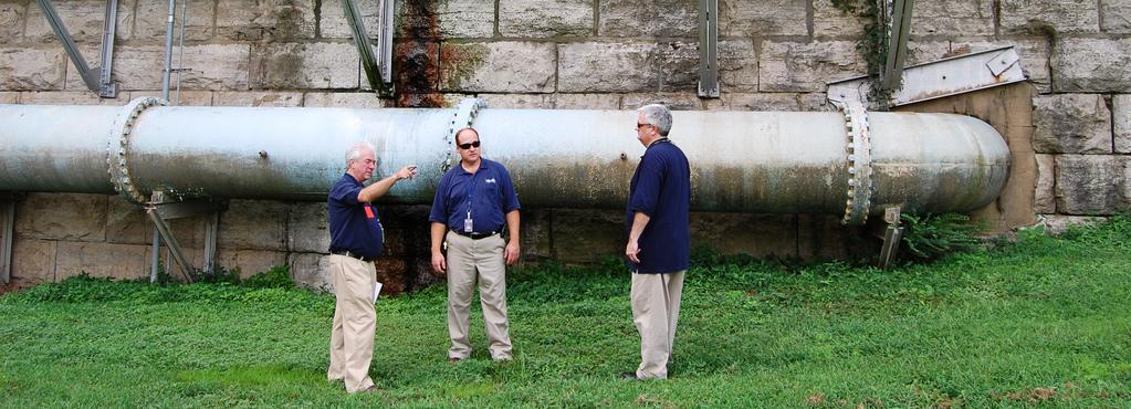 FEMA Hazard Mitigation Specialists Larry Koski (left) and Michael Connor (right) discuss options for protecting Nashville s historical Omohundro Treatment Plant from future floods with Metro Water