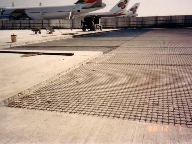 Tensar AR1 asphalt grid was used in strips over joints on an old concrete pavement that was being resurfaced 1980 s, Asphalt Reinforcement, Linkoping Airport, Sweden Tensar Asphalt