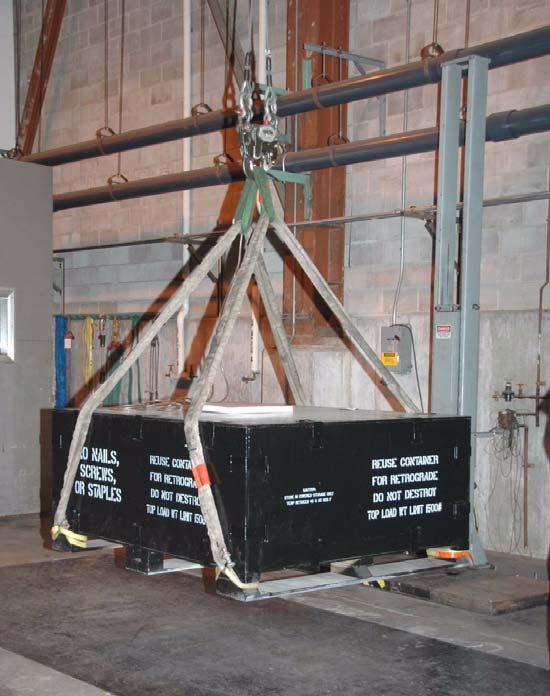 TEST PROCEDURES AND RESULTS Figure 5. 18-inch Free-Fall Drop Test 3. Edgewise Drop Test One edge of the loaded container was placed on a 6-inch block.