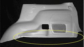 The door panel has a 90-degree bend near the speaker grill that warps severely when the cooling time is too short (Figure 15).