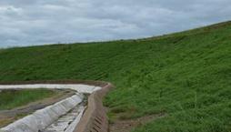Garland drain was provided to channelize runoff water. At slope vegetation was provided so that erosion is minimized in first year itself.