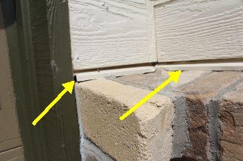 The flashing pieces were loose or gapped above the brick veneer adjacent to the garage doors.