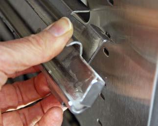 After inserting the top tab, push up slightly on it while snapping in the bottom tab into a slot located 3 slots below the top slot. (Figure 12) 3.