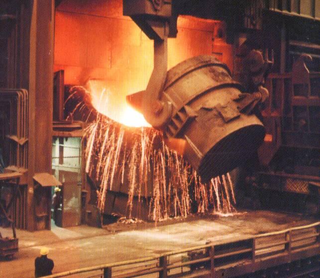 A spectacular scene in steelmaking is charging of a basic oxygen furnace, in which molten pig iron produced in a