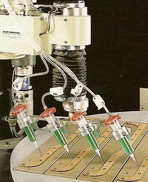 Automated dispensing of adhesive onto component parts prior