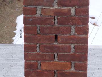No Gutters Noted No Gutters Noted Chimney pointing is moderately worn in one area. This allows water to infiltrate the brick and mortar, causing further damage to chimney.
