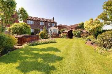 There is shaped adjoining lawned gardens with well stocked flowered borders and second feature pond with a dipped fenced rear boundary making the most of the superb views.