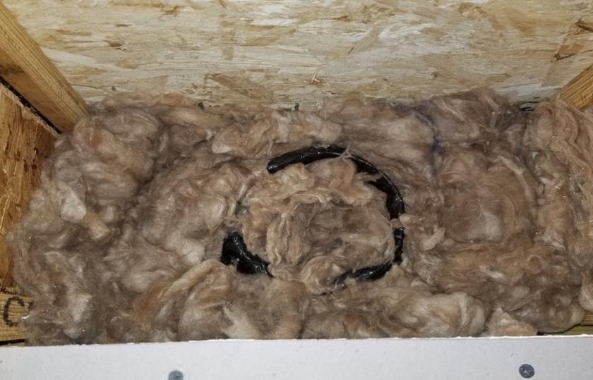 Figure 12-2. Insulation Filled Around Future Fan Vent Duct. 12.3.3. HVAC 1. Vacuum debris from the sub-flooring around all in-floor heating ducts as well as the inside area around the top of the duct.