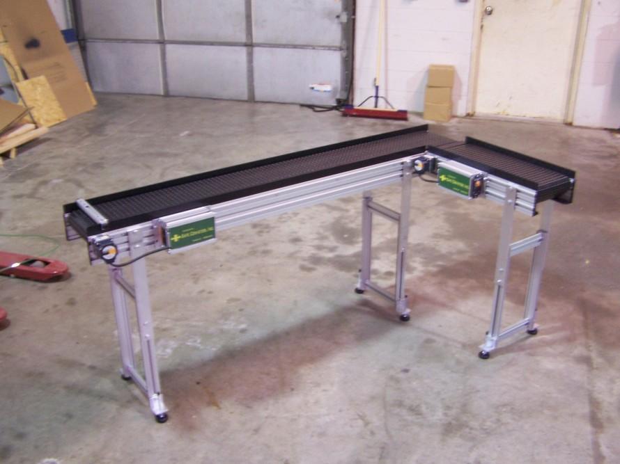 Items can be quickly dropped on the end of the conveyor and the guide rail diverts the product to the side to get all of the products orientated the same way.