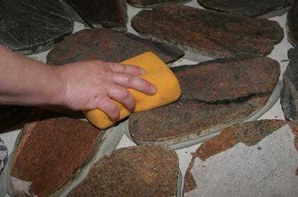 Step 7 Wash the Stone Carefully inspect the stone surfaces and remove any extra thin set mortar material. This can be achieved by rubbing the surface with a wire hand brush.