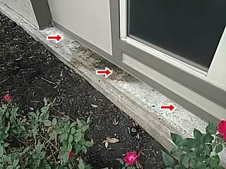 At other locations the lower edge of the stucco is et behind a curb that appears to