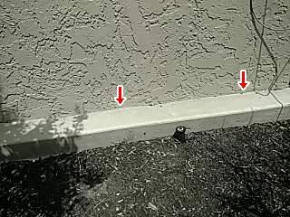 Stucco set behind curb The trim is in contact with ground.