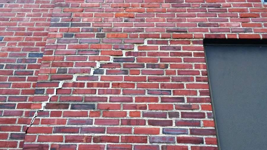 PHOTO #19 This photo shows a previously repaired crack (and displaced brick) in the