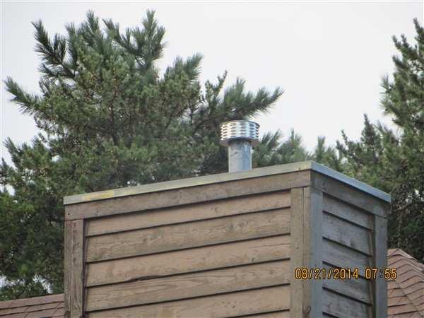 11 LOCATION: Roof, Upper SYSTEM: Roof Metal enclosed chimney cap pools water Metal cap designed to shed water is collecting water.