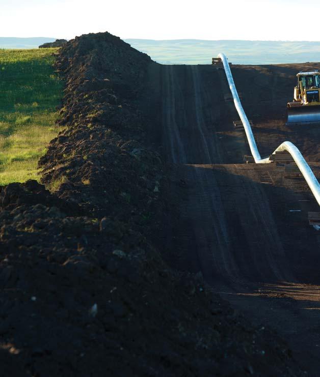 GROUND PREPARATION: Construction equipment levels a Caliber Midstream right-of-way for high-diameter crude oil pipeline (left) and natural gas pipeline (right) in McKenzie County, North Dakota.