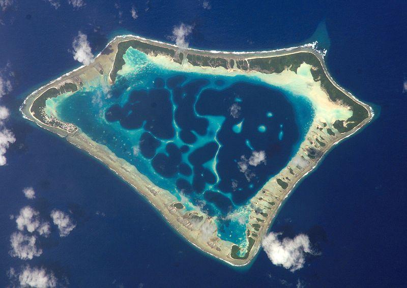Atoll - an island of coral that encircles a lagoon partially or
