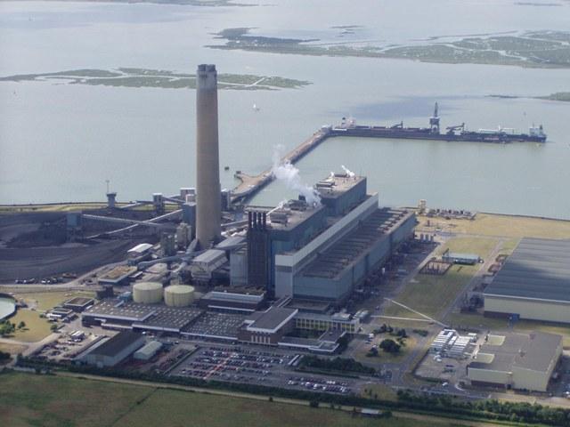 In some power stations an energy source is used to heat water. The steam produced drives a turbine that is coupled to an electrical generator. The photograph shows a power station.