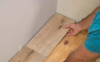 Starting from the left with the tongue-side facing the wall, carefully place the first board in place, using spacers to leave a ¼ expansion gap between wall and edges of the plank. 2.