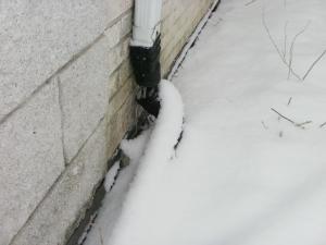 Picture Date:2/26/2015 Downspouts: REPAIR or REPLACE - The downspout discharge drains close to the house. As a rule of thumb, a minimum drainage of six feet from the house is recommended.