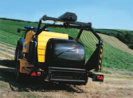 A transfer fork fully cradles the ejected bale while it is moved to the wrapping table and a pair of hinged guides prevent it from sliding sideways.