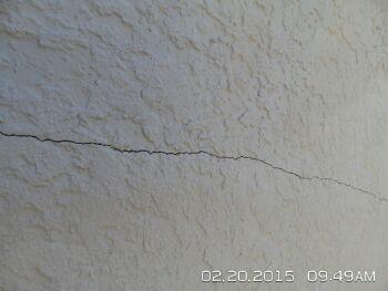 Cracking observed at several areas around home. Appears to have been repaired once already and has cracked again.
