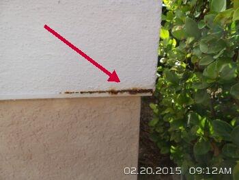 Areas of stucco show rust and deterioration of underlying metal corners. This is a sign of possible moisture in the wall space.