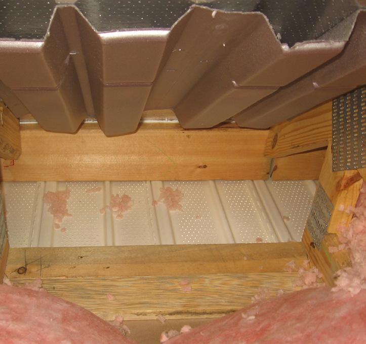 For vented attics, install wind baffles on top of all
