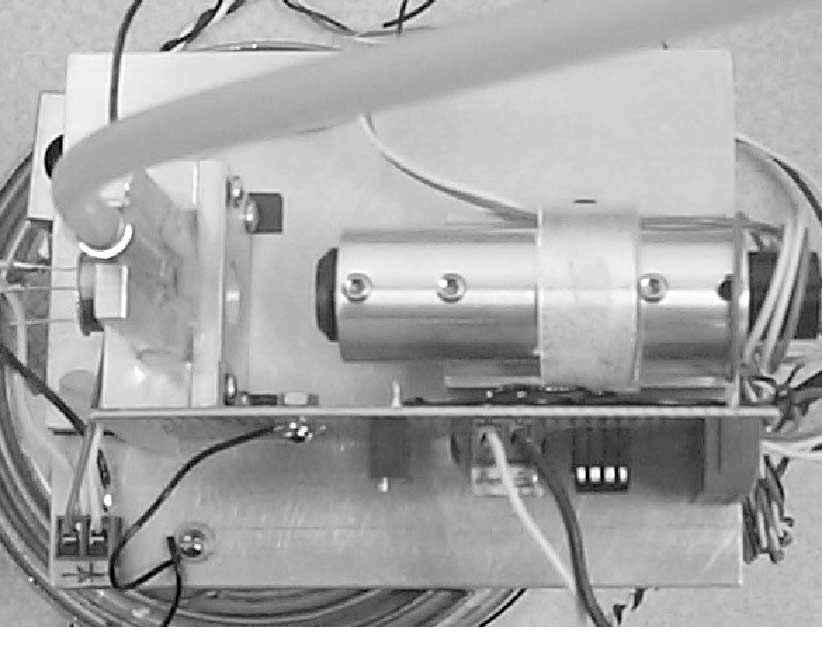The components are installed in such a way that the laser beam emitted from the laser diode passes through the powder stream owing inside the glass chamber and is received by the photodiode (Fig. 1a).