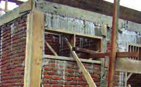 Bricks in lintel are inclined in both directions Roof beam is extended down to top edge of