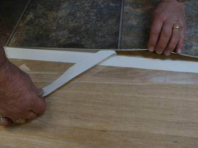 Position Tarkett Floating Seam Tape so that it is centered under the seam cut.