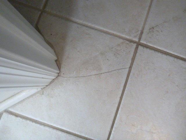 Bathroom #2-1st Floor Right: View of cracked bathroom ceramic floor tiles BATHROOM #3-2ND FLOOR Recommend Repairs CEILINGS WALL(S) WINDOWS/TRIM WINDOW SCREENS FLOOR/FINISH INTERIOR DOORS/HARDWARE