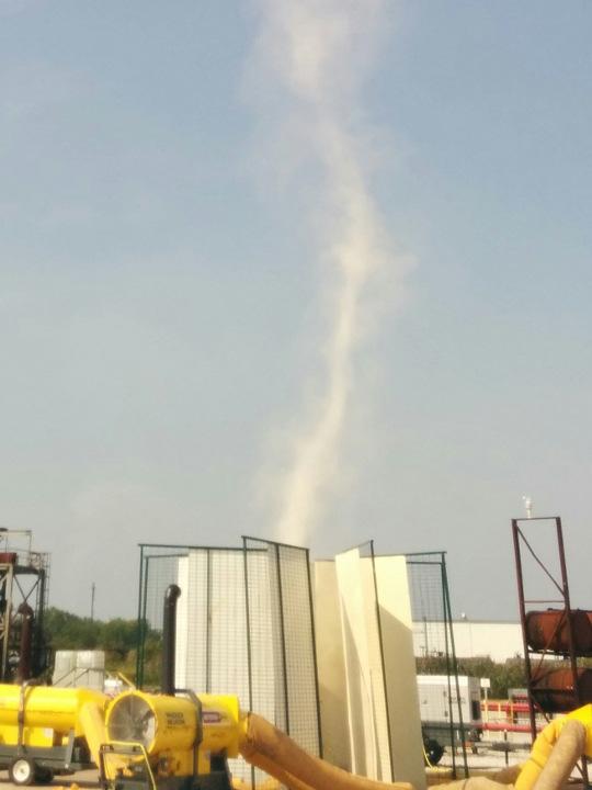 Fig. 4 Unenclosed Prototype Vortex made visible with white smoke emitter Raising 24 C saturated surface air can produce a specific work of 3400 J/kg corresponding to force 5 hurricane winds of 82 m/s.