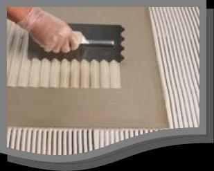 27 APPLICATION Using a suitable notched floor trowel held at a 45 o angle, spread the adhesive onto the floor to form parallel ribs into which the tiles should be pushed with a firm twisting action,