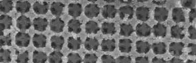 A structural analysis of the sample performed by SEM reveals that the growth takes place layer by layer, which gives rise to a uniform shell coating of the silica spheres.