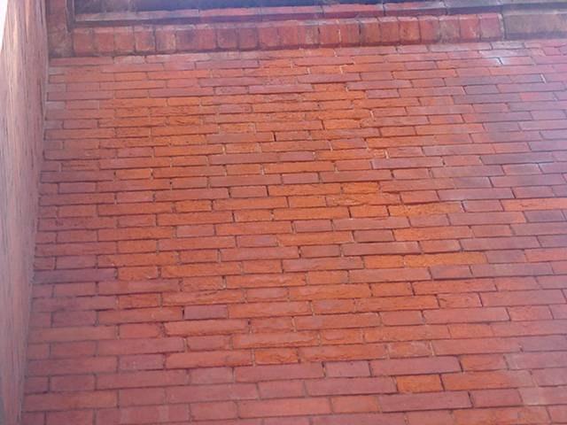 Walls: Flemish bond brickwork bedded originally in a lime mortar, with cement mortar