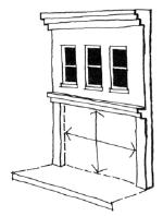 The storefront should be bounded by the enframing storefront cornice and piers on the side and the sidewalk on the bottom. Remodeled storefronts should be designed to fit within the original opening.