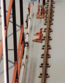 The bottom guide rail A RN-45 type track or equivalent is fastened to the concrete slab with support plates having anti-vibration plastic insulators