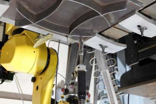 Figure 7. Canfield University gas metal arc welding robot depositing material [13].