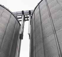 block b) Storage silos for powdery raw materials - 46 pcs of 100 m³ and 50 m³ silos for powdery raw materials.