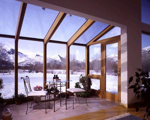 A sunroom with enclosed walls. The sunroom is designed to be heated or cooled and is open to the main structure.