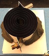 Figure 2. Left: Six-turn Swiss-roll combustor mounted on a ceramic board. The top insulation is removed to show the internal structure.