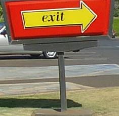 Standards: Directional Signs for Parking Lots may be freestanding Ground Signs or wall-mounted if Parking Lot is adjacent to a Building.