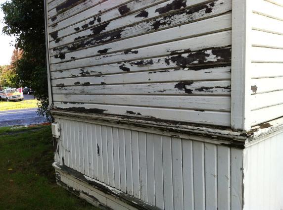 Many of the siding boards show decay and dry rot damage especially along the base of the walls at the foundation level.