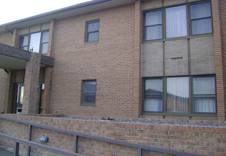 Photo 1: Typical view of Building 68 with brick exterior and asphalt built-up roof.