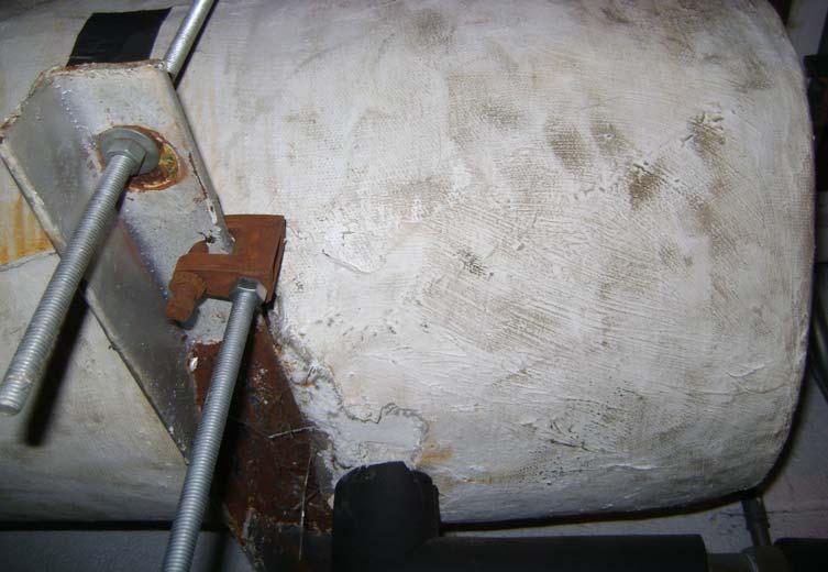 Photo 3: View of asbestos-containing mudded tank in mechanical room.