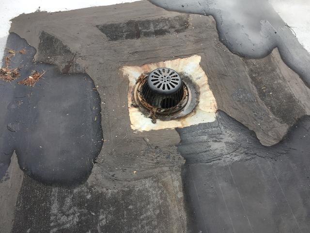 Photo 15 Many of the drains on this roof have been repaired,