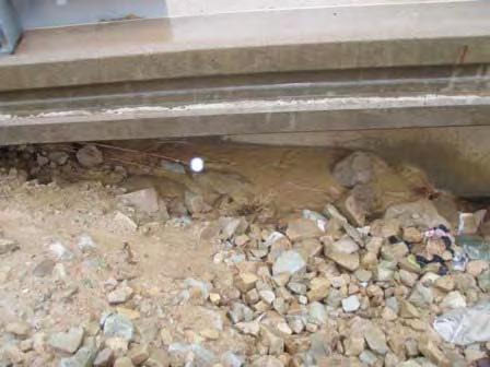 Discharge from pipe seeping out of rocks below