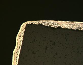 Microscopic image of a micro-section of a tombstoning resistor.