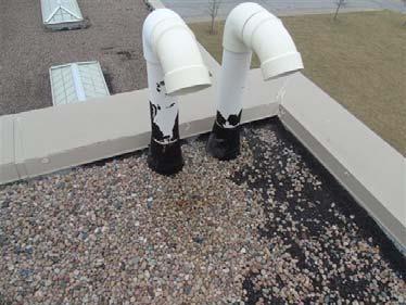 Repair: Raise flashing height to a minimum of 8" above finished roof surface.